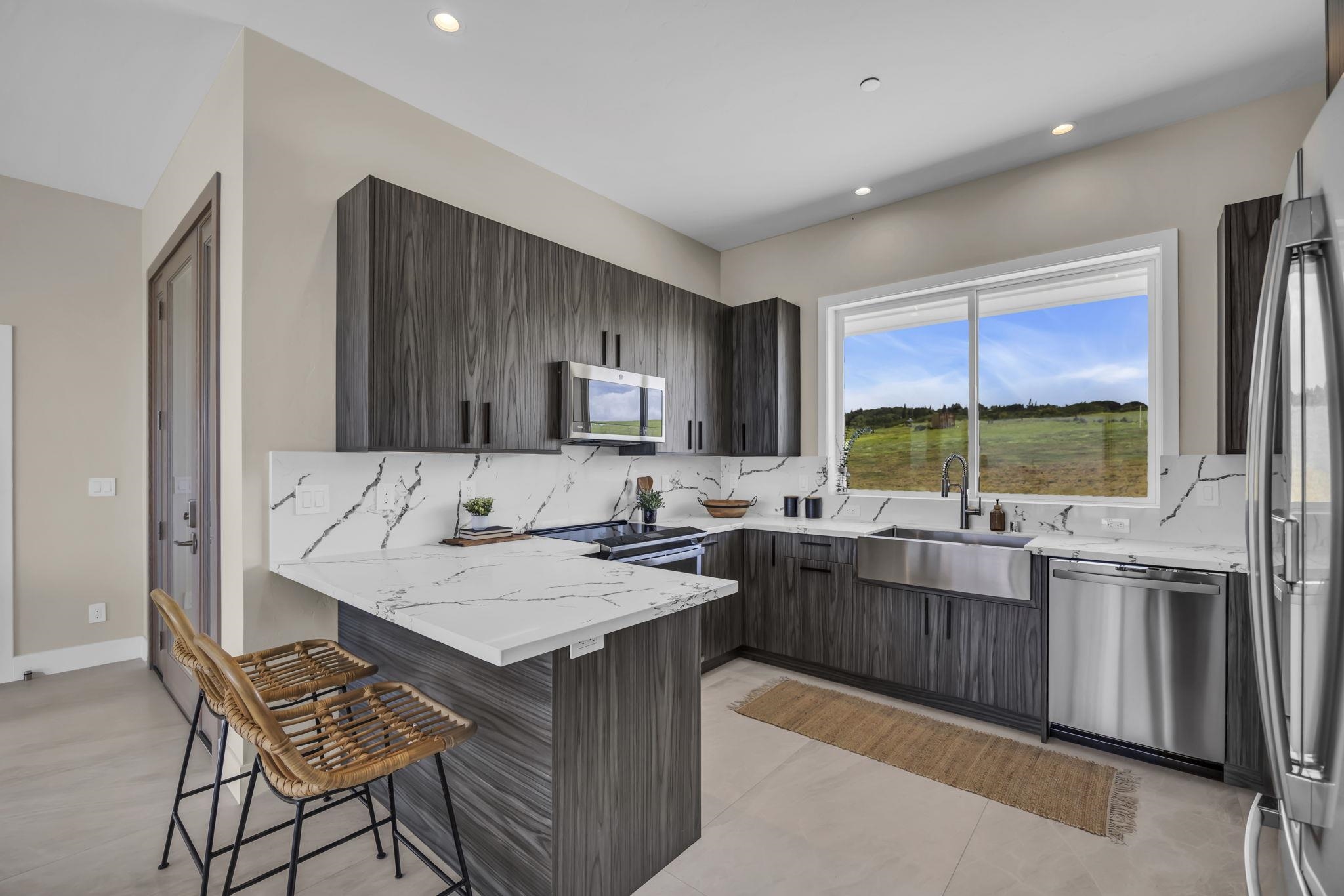 500 Kai Huki Circle, Unit B Haiku, HI 96708 - Photo 7 of 50 a kitchen with a stove a sink and a refrigerator