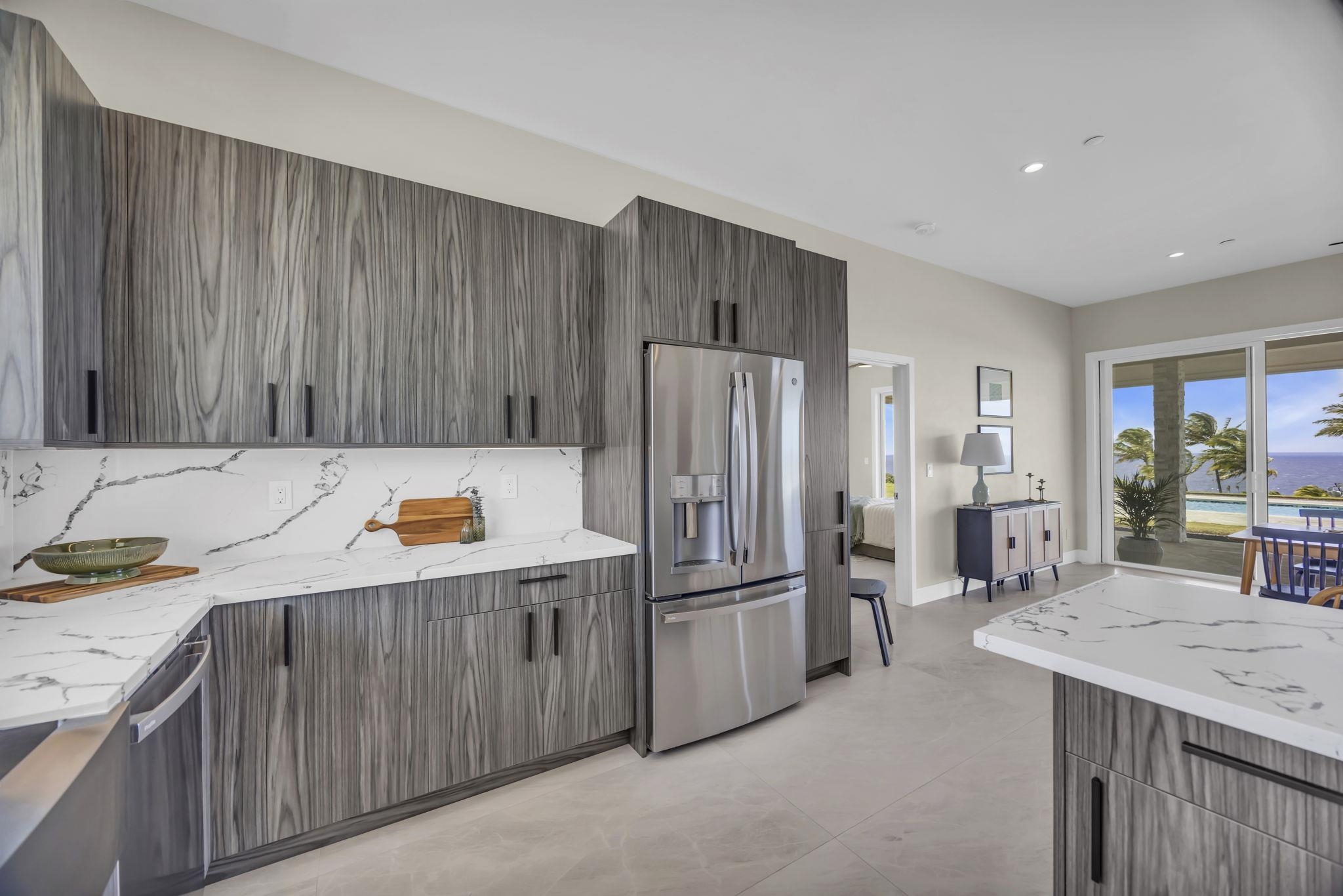 500 Kai Huki Circle, Unit B Haiku, HI 96708 - Photo 8 of 50 a kitchen with stainless steel appliances a refrigerator and a sink