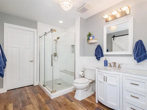 a bathroom with a toilet sink and shower
