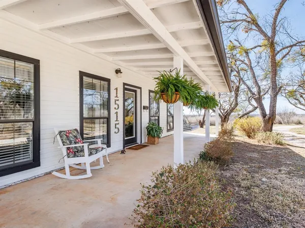 a view of a chairs and table in backyard of a house