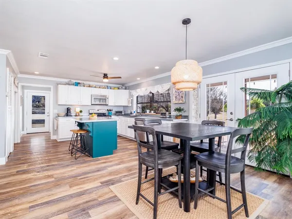 a dining room with furniture and wooden floor