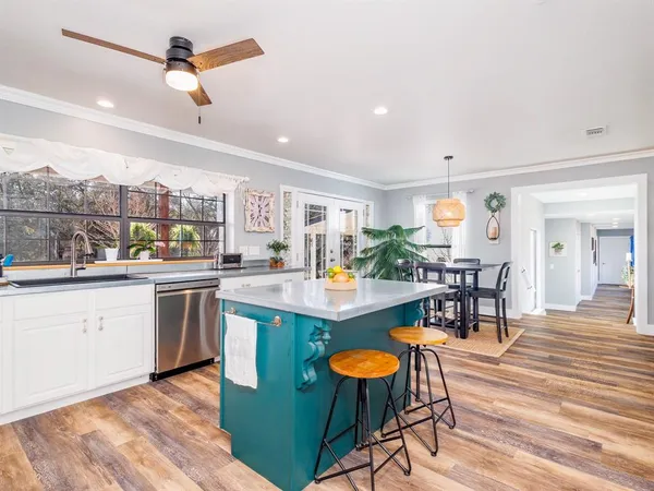 a kitchen with stainless steel appliances kitchen island a large island in the center