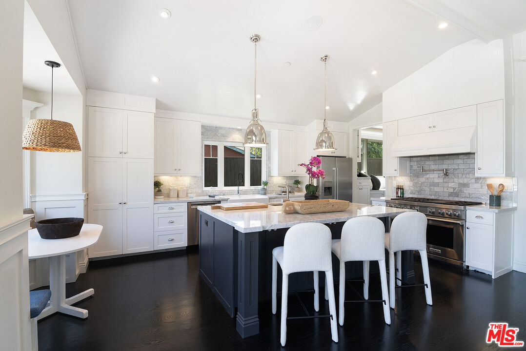 2737 Angus Street Los Angeles, CA 90039 - Photo 19 of 56 a kitchen with kitchen island granite countertop a table and chairs