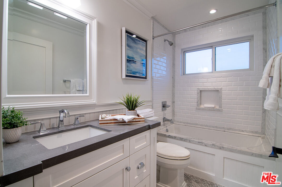 2737 Angus Street Los Angeles, CA 90039 - Photo 29 of 56 a bathroom with a granite countertop sink a toilet and shower
