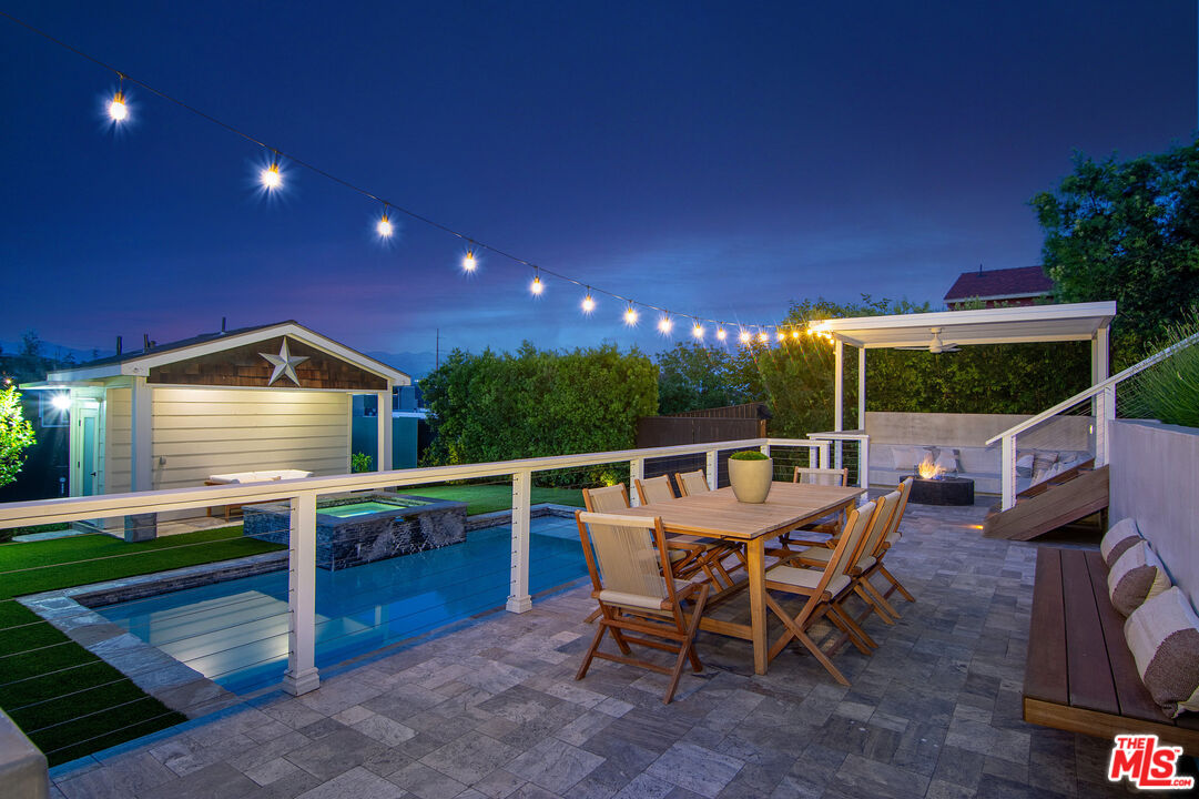 2737 Angus Street Los Angeles, CA 90039 - Photo 46 of 56 a view of a roof deck with table and chairs a barbeque with wooden floor and fence