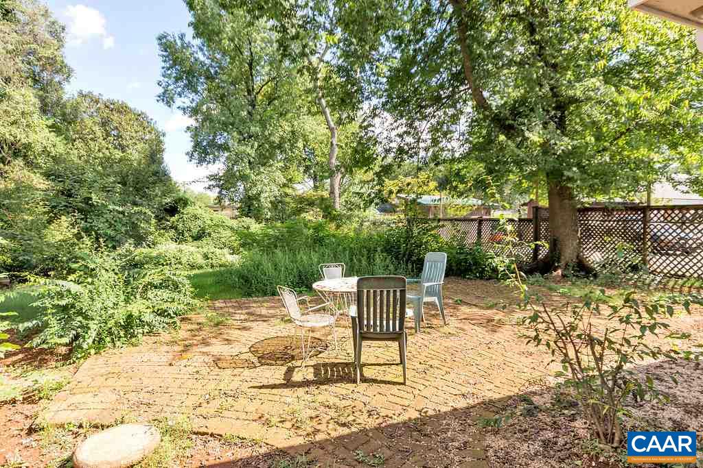 1628 St Annes Road Charlottesville, VA 22901 - Photo 18 of 20 a view of backyard with a table and chair and wooden fence
