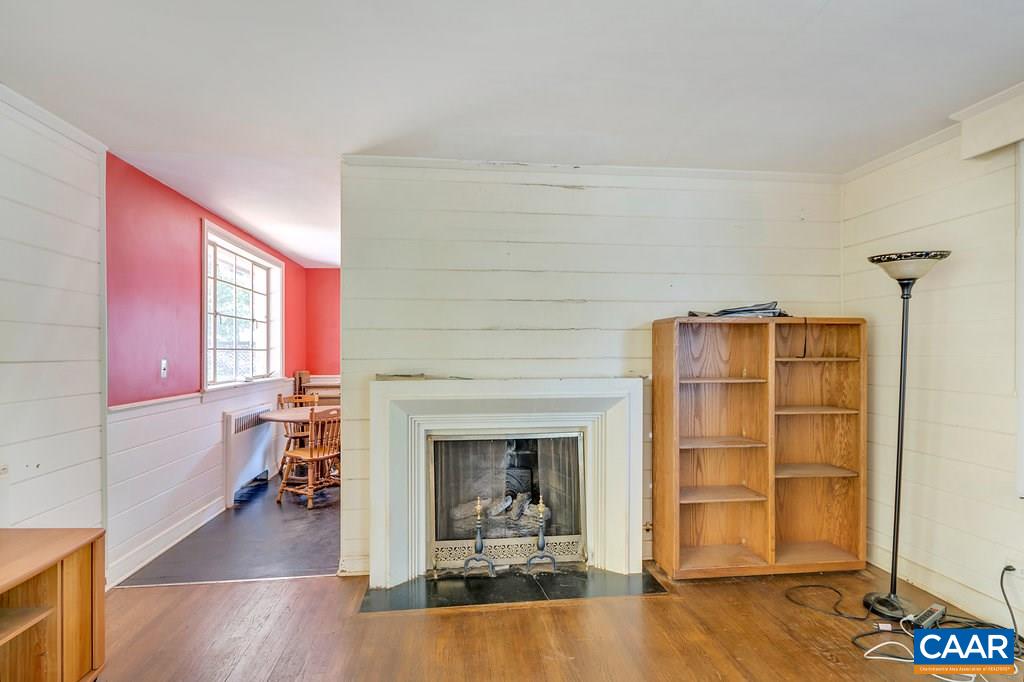 1628 St Annes Road Charlottesville, VA 22901 - Photo 7 of 20 a view of a livingroom with wooden floor a fireplace and window