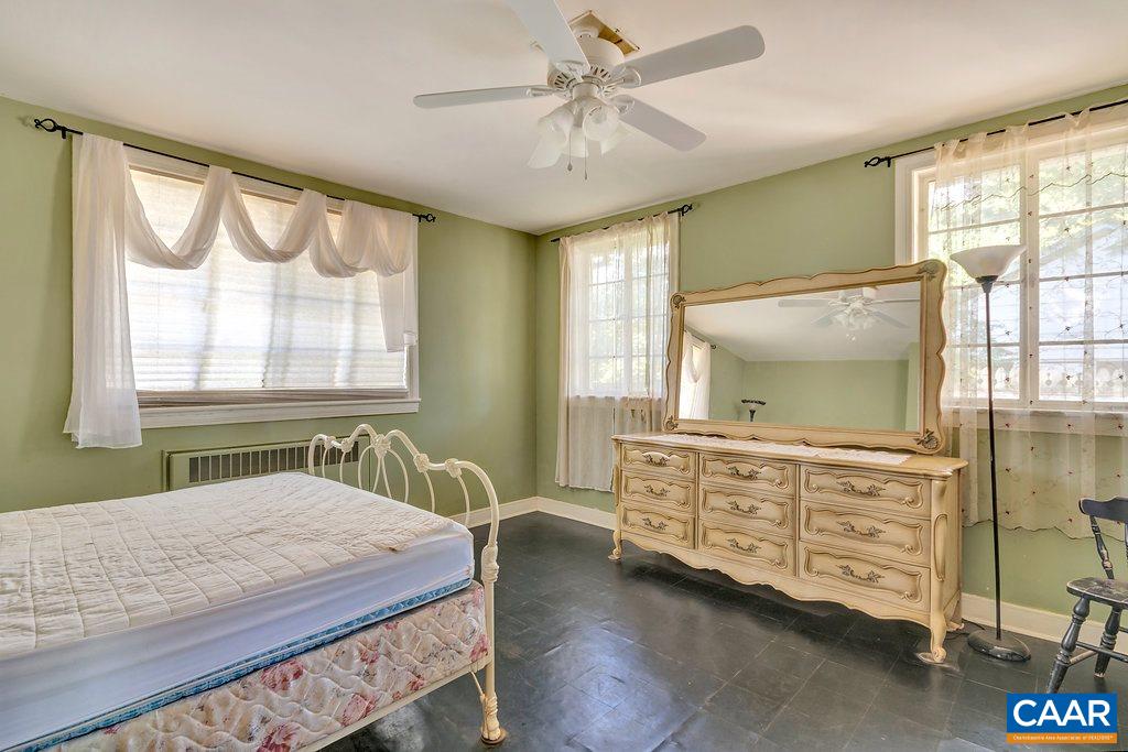 1628 St Annes Road Charlottesville, VA 22901 - Photo 10 of 20 a bedroom with a bed and a flat tv screen on the dresser