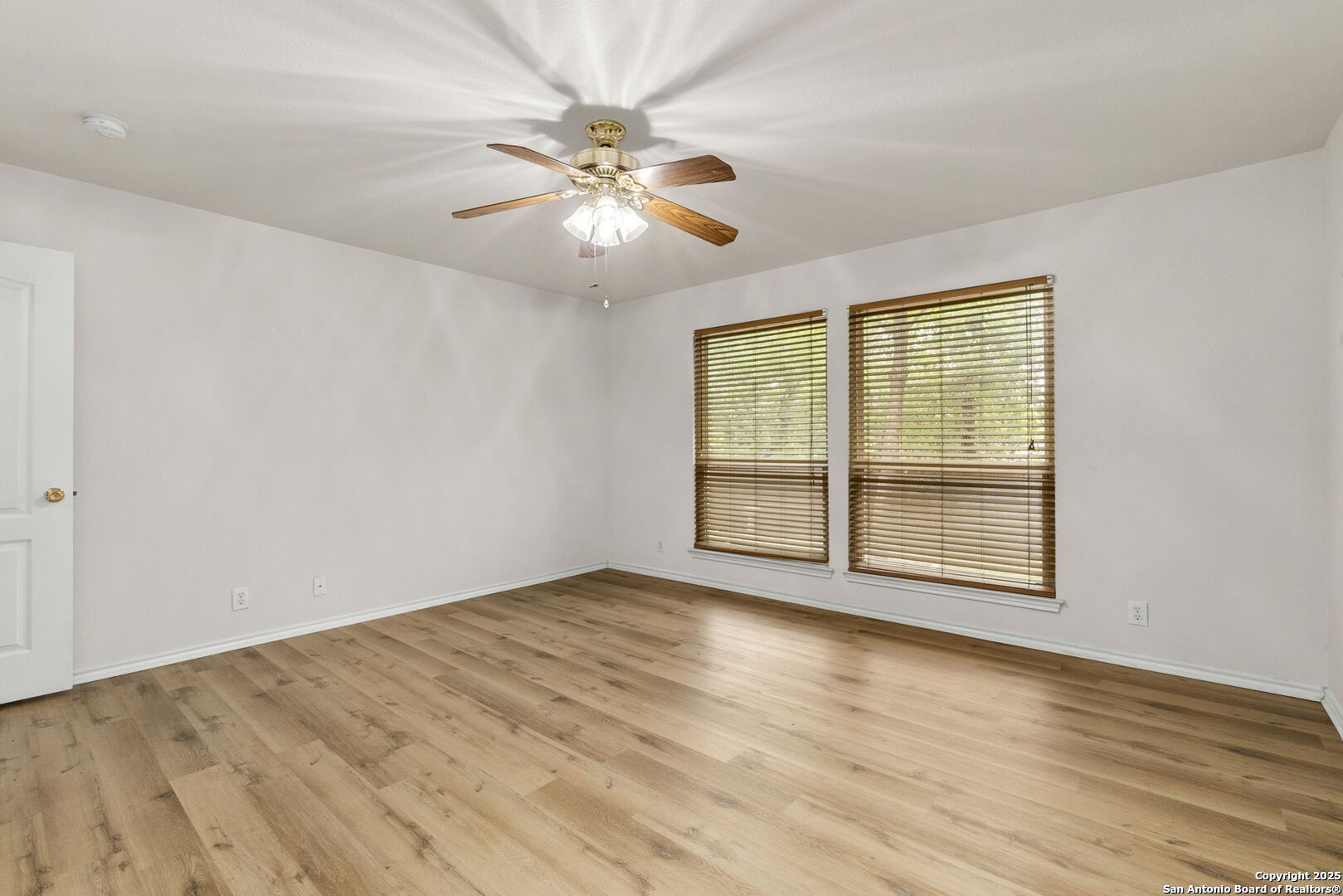 15311 Spring Rock San Antonio, TX 78247 - Photo 18 of 32 a view of an empty room with wooden floor and a window