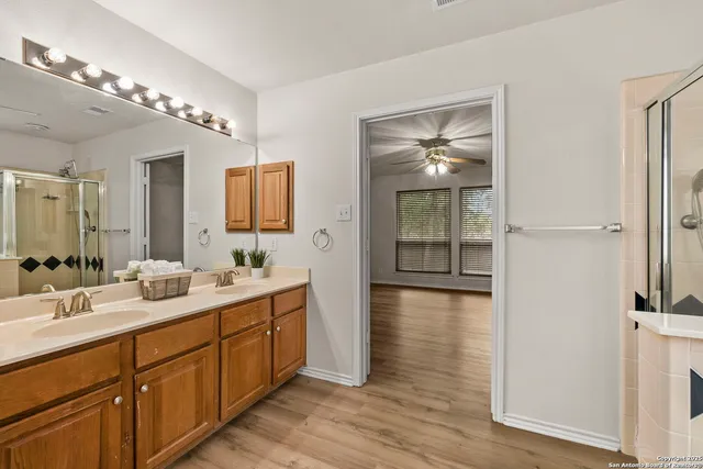 a spacious bathroom with a double vanity sink and a mirror