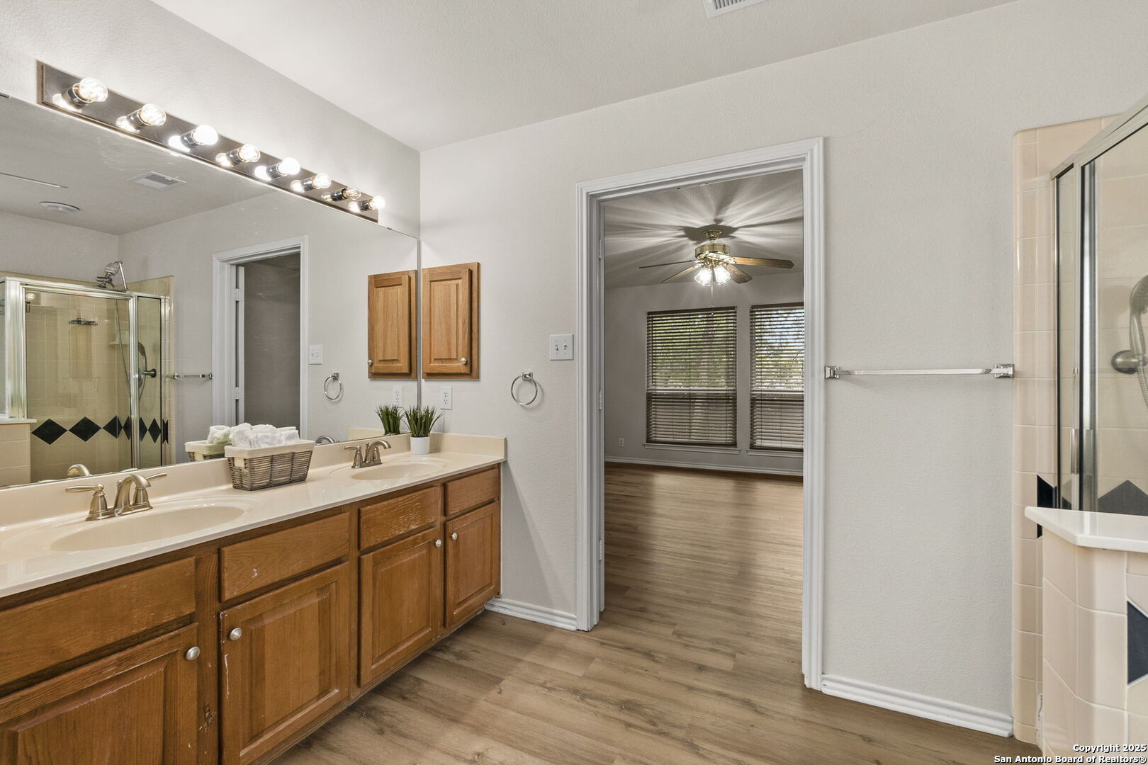15311 Spring Rock San Antonio, TX 78247 - Photo 20 of 32 a spacious bathroom with a double vanity sink and a mirror