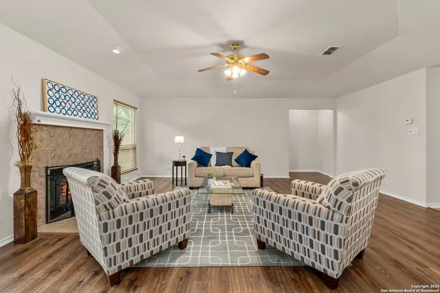 a living room with furniture and a fireplace