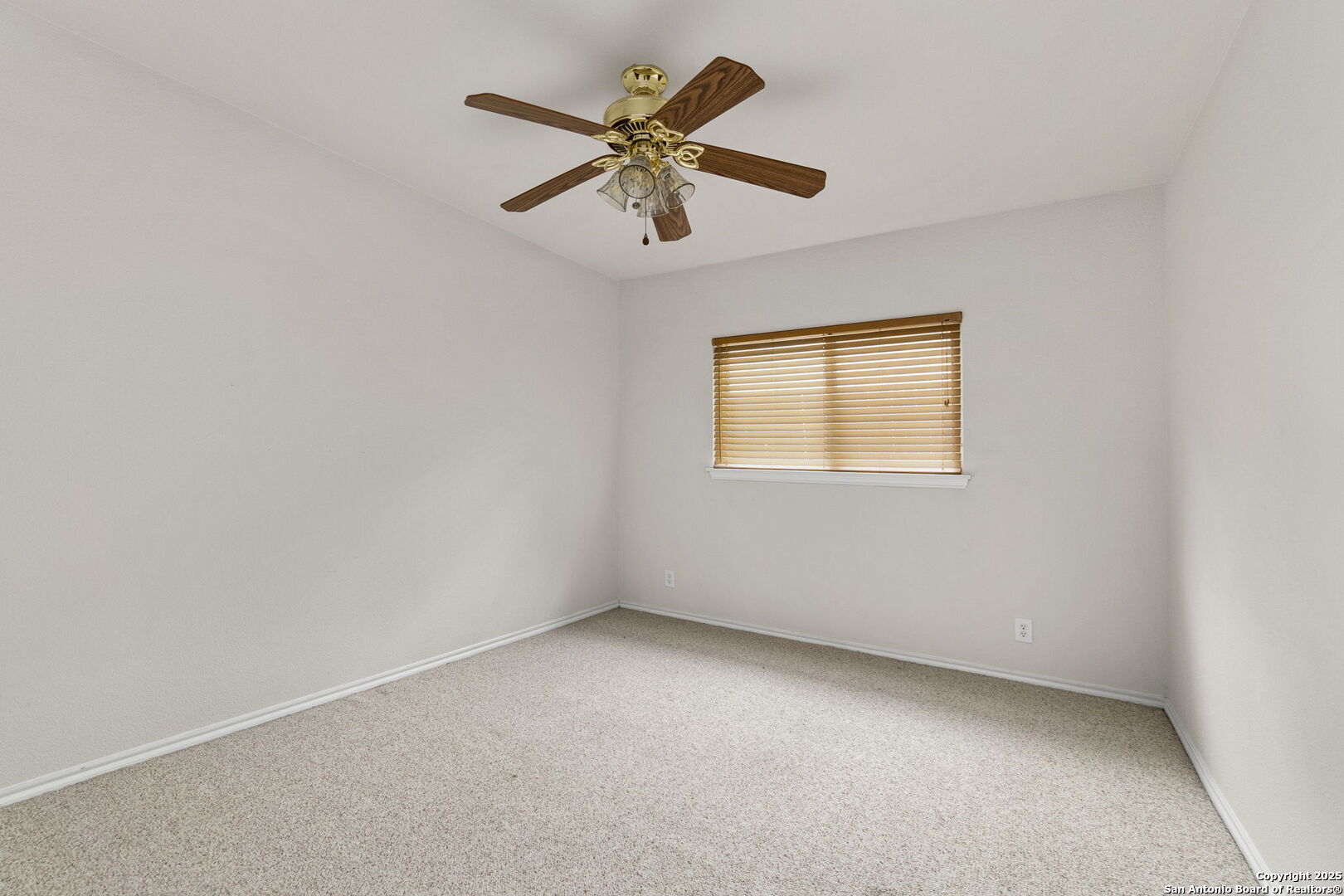 15311 Spring Rock San Antonio, TX 78247 - Photo 24 of 32 an empty room with a window and a fan