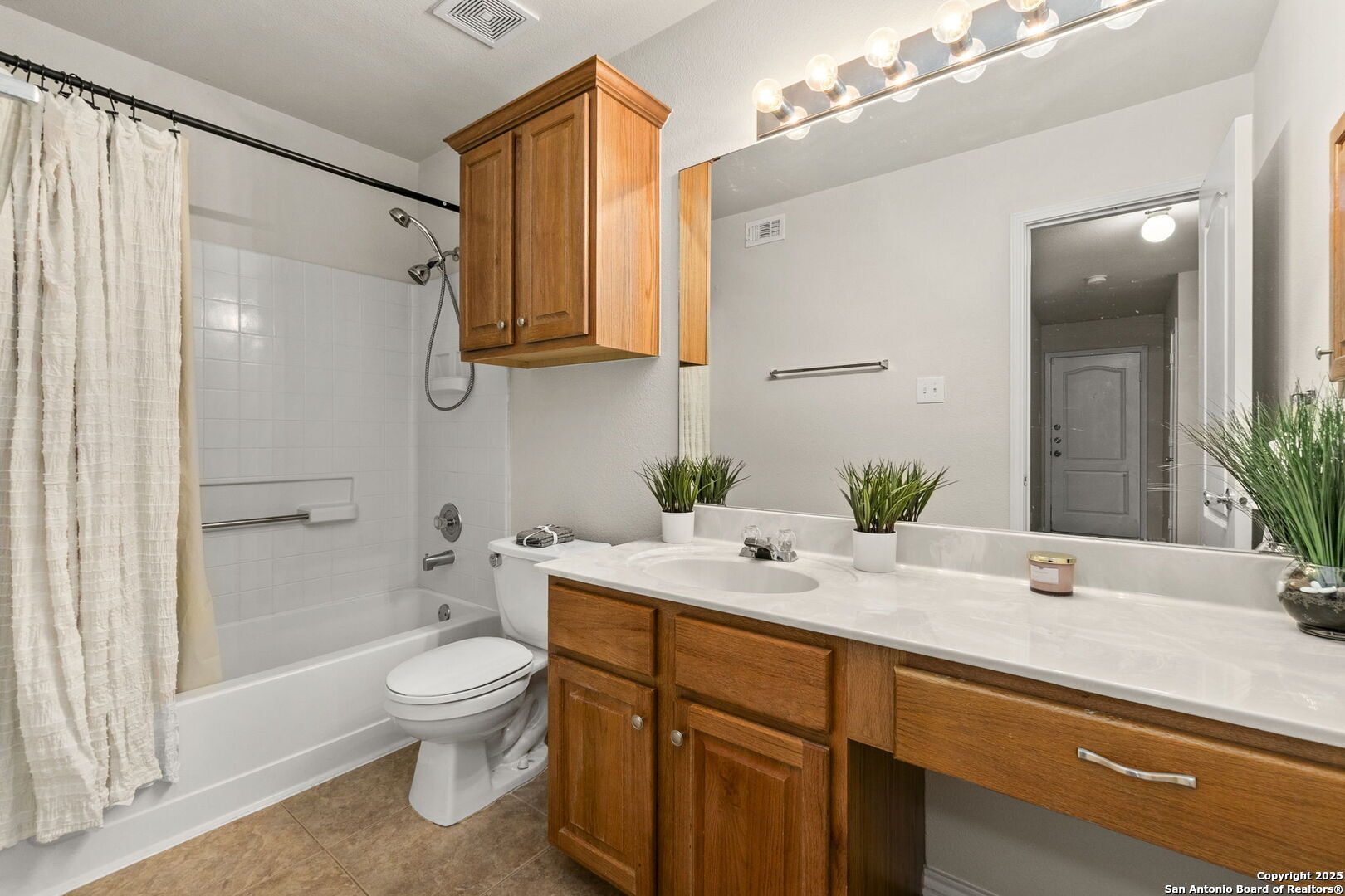 15311 Spring Rock San Antonio, TX 78247 - Photo 26 of 32 a bathroom with a sink a toilet and shower