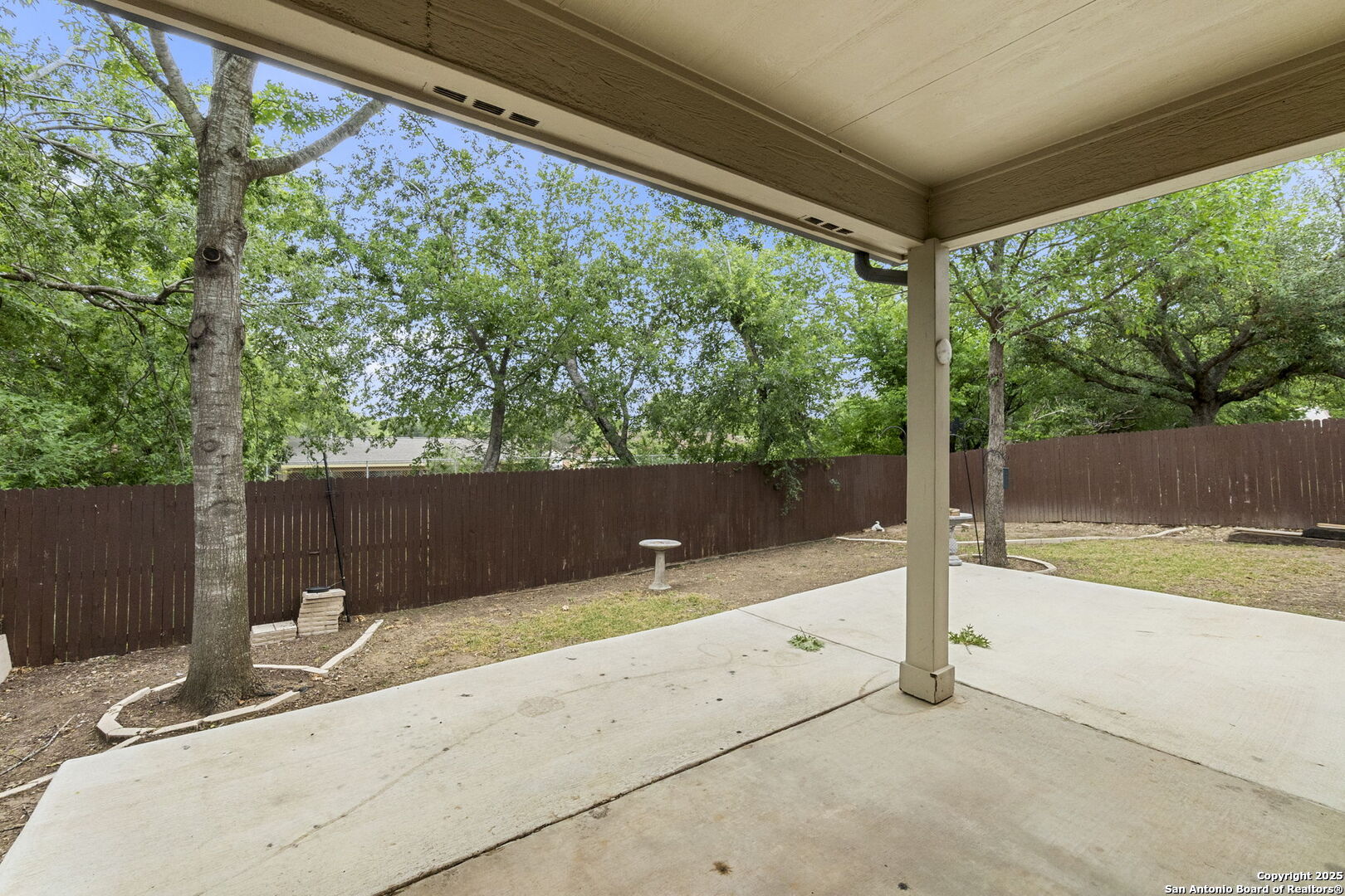 15311 Spring Rock San Antonio, TX 78247 - Photo 29 of 32 a backyard of a house with a tree and wooden fence