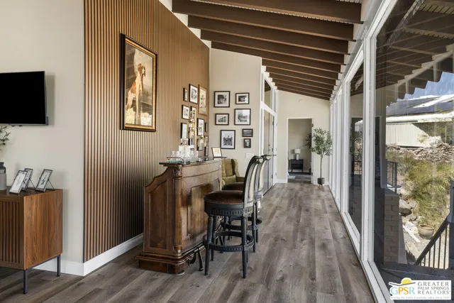 a dining room with furniture wooden floor and a rug