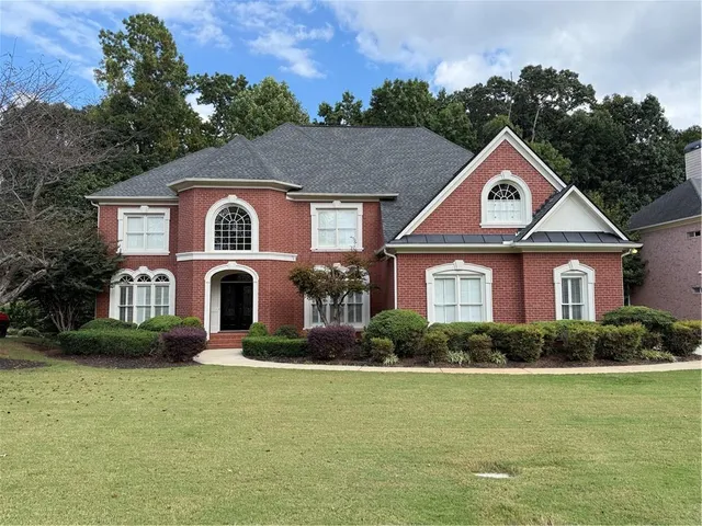 a front view of house with yard and green space