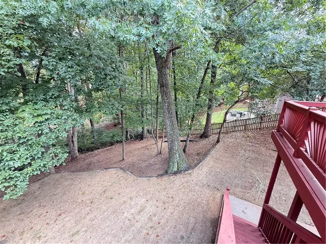 a view of a roof deck with wooden floor and fence