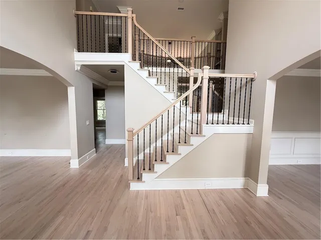 a view of entryway and hall with wooden floor
