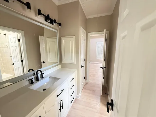 a view of a hallway with wooden floor and windows