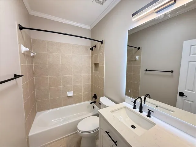 an empty room with windows fireplace and a ceiling fan