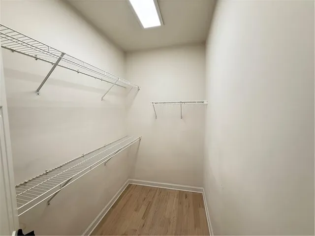 a bathroom with a tub double vanity sink and a large mirror