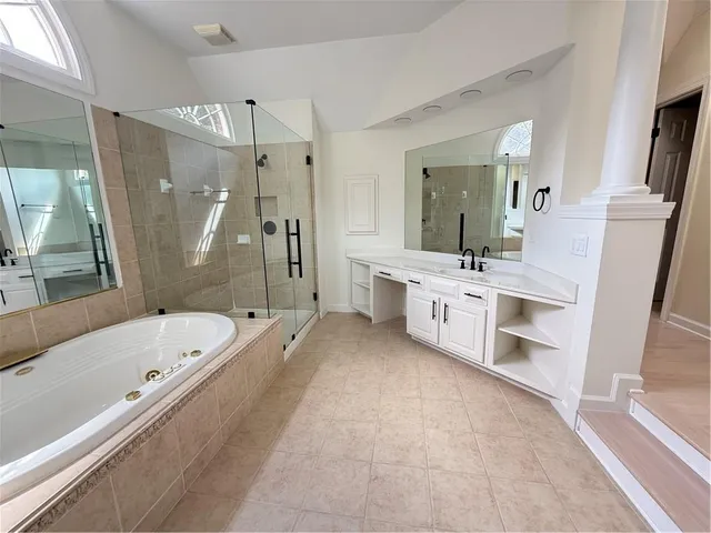 a bathroom with a tub and a shower