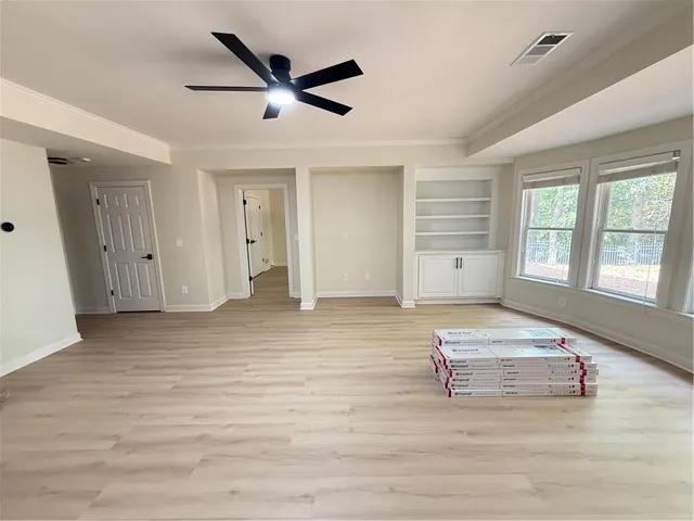 wooden floor in an empty room with a window