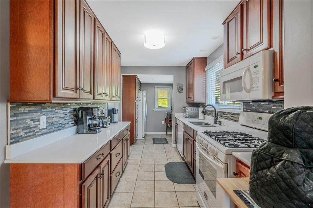 4101 Miracle Ridge Road Monongahela, PA 15063 - Photo 11 of 47 a kitchen with stainless steel appliances granite countertop a stove a sink dishwasher and cabinets with wooden floor