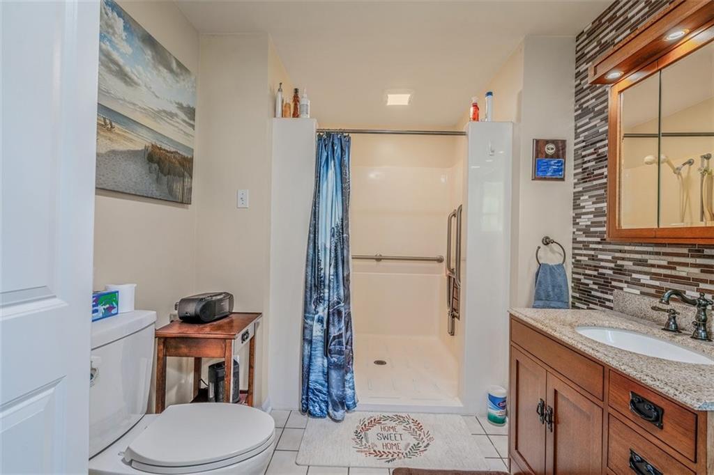 4101 Miracle Ridge Road Monongahela, PA 15063 - Photo 19 of 47 a bathroom with a granite countertop sink toilet and shower