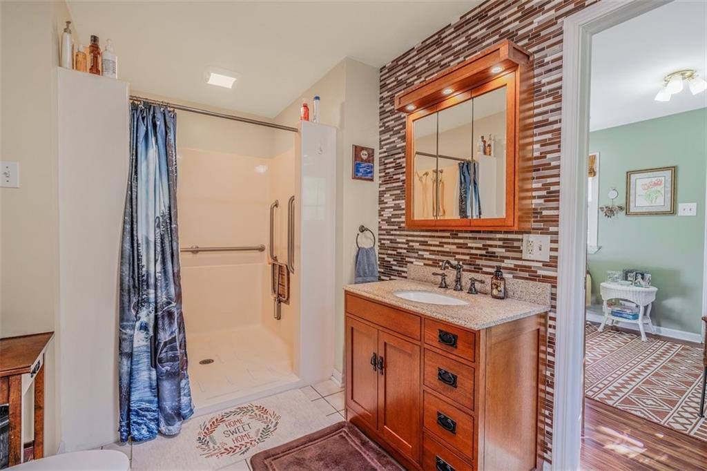 4101 Miracle Ridge Road Monongahela, PA 15063 - Photo 21 of 47 a bathroom with a sink a mirror and a shower