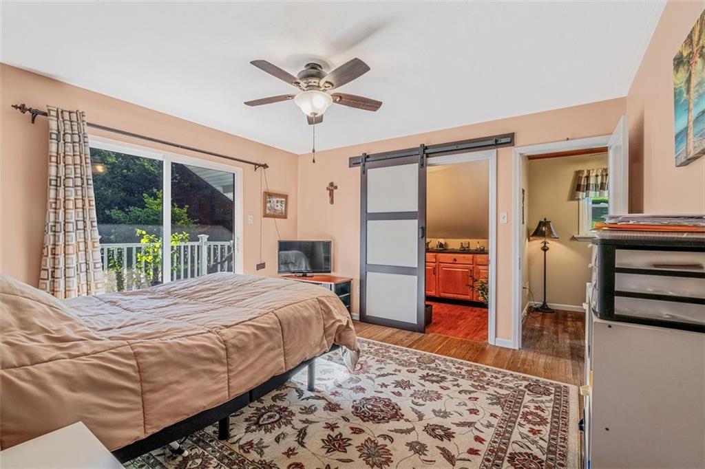 4101 Miracle Ridge Road Monongahela, PA 15063 - Photo 29 of 47 a bedroom with a bed and wooden floor