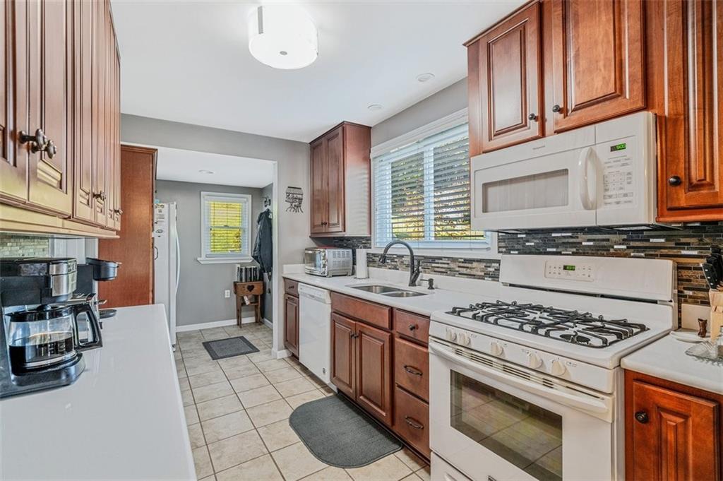 4101 Miracle Ridge Road Monongahela, PA 15063 - Photo 10 of 47 a kitchen with stainless steel appliances a stove a sink cabinets and a window