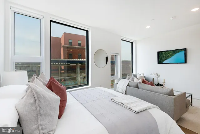 a bedroom with a bed and glass window