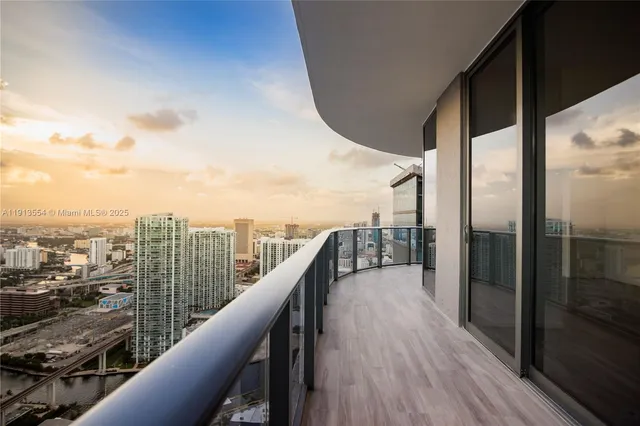 a balcony with wooden floor and city view