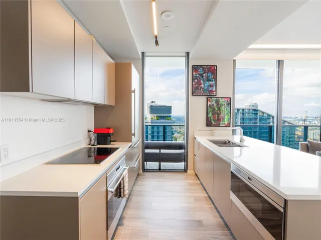 a large kitchen with a large window