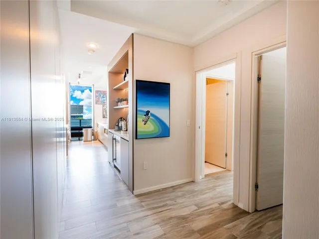 a view of a hallway view with wooden floor and windows
