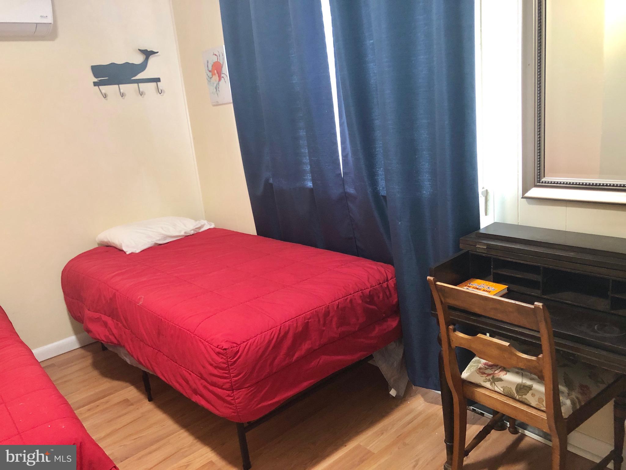 332 Arbutus Drive Edgewater, MD 21037 - Photo 14 of 31 a bed sitting in a bedroom next to a window