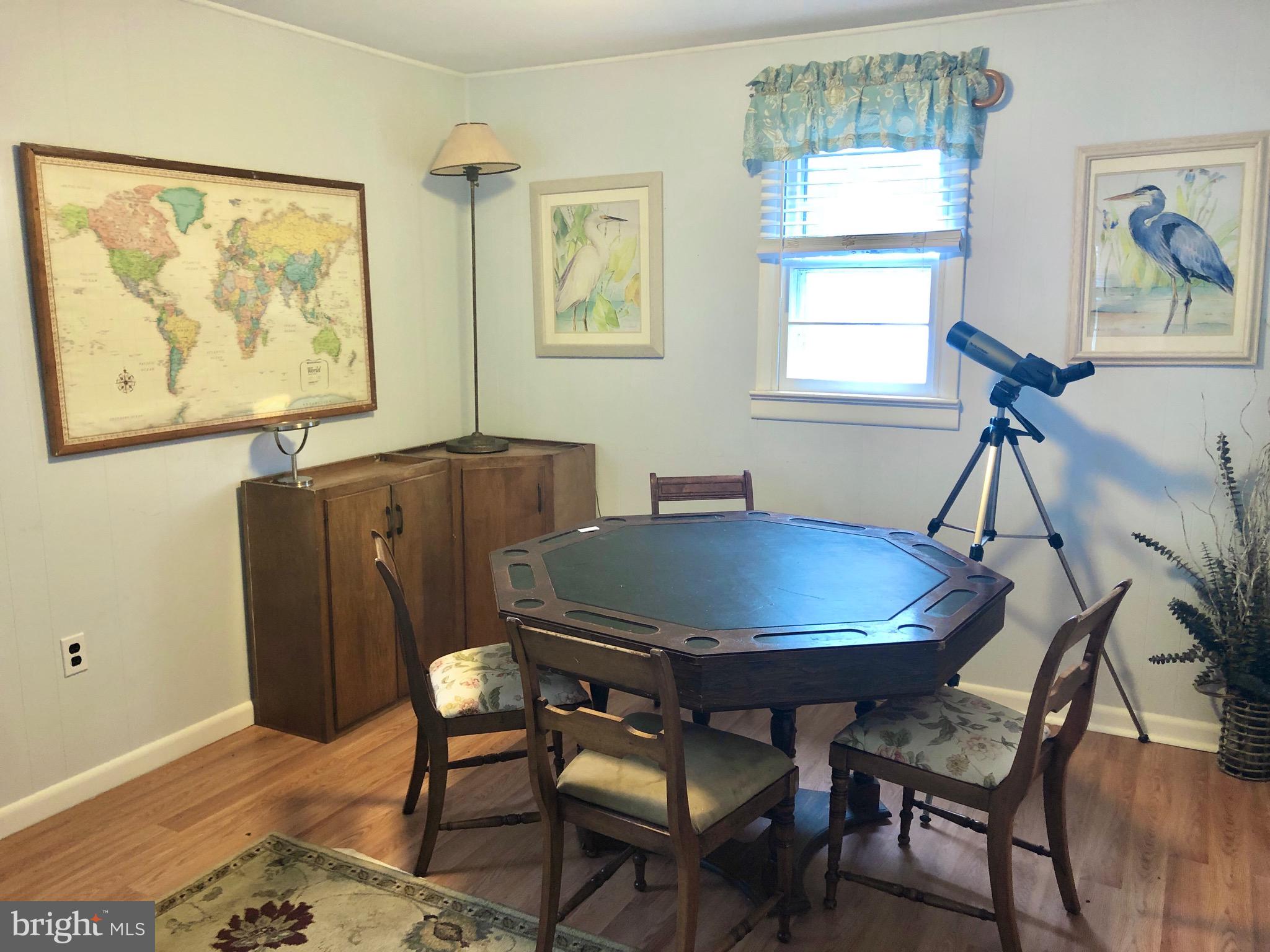 332 Arbutus Drive Edgewater, MD 21037 - Photo 15 of 31 a view of a dining room with furniture a rug and wooden floor