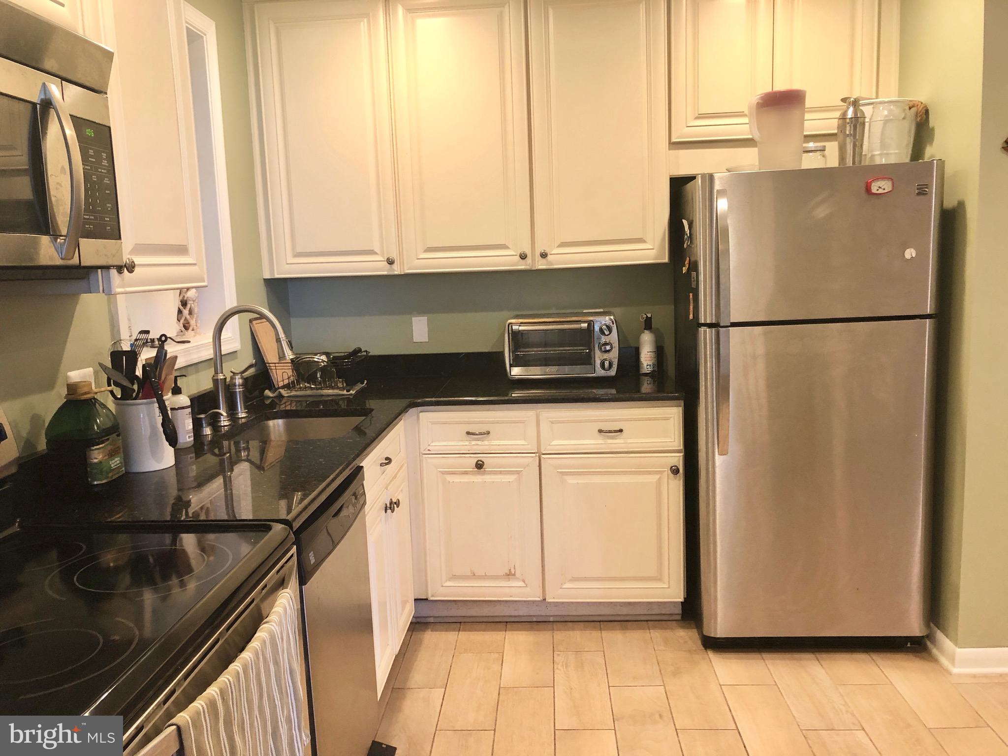 332 Arbutus Drive Edgewater, MD 21037 - Photo 3 of 31 a kitchen with appliances a sink and cabinets