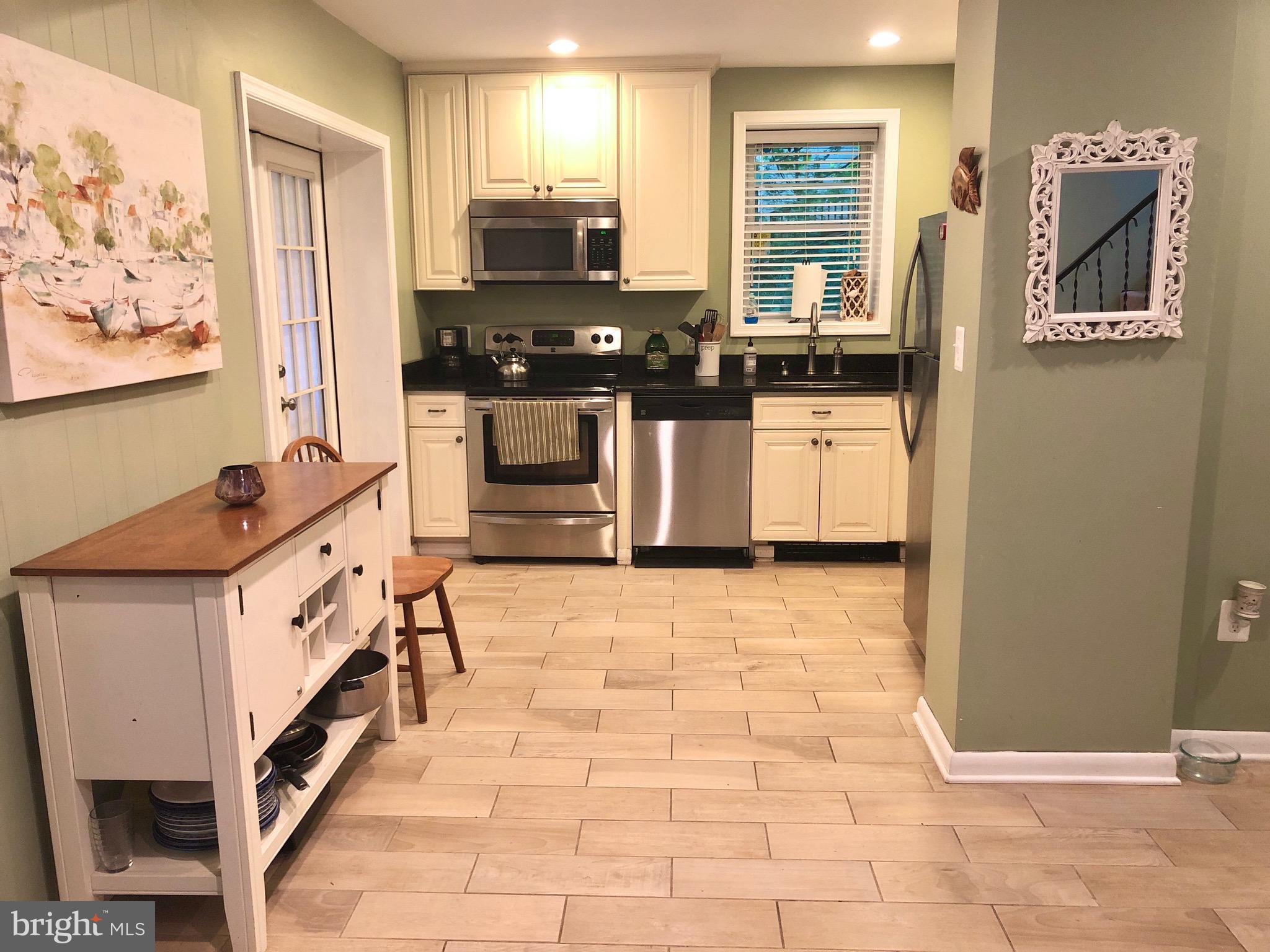 332 Arbutus Drive Edgewater, MD 21037 - Photo 5 of 31 a kitchen with stainless steel appliances a stove top oven a sink a counter space and cabinets