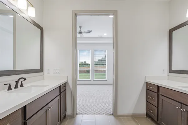 a bathroom with a sink vanity and a mirror