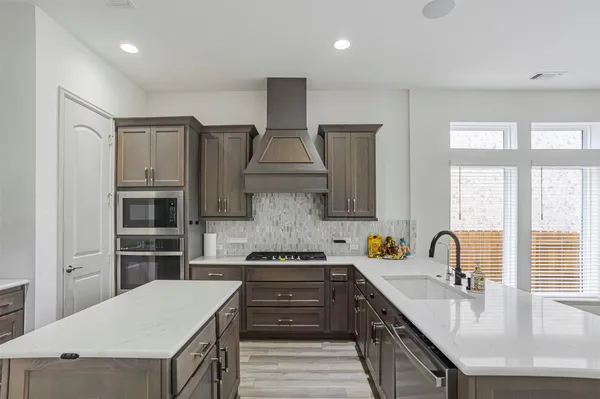 a kitchen with a sink stove and refrigerator