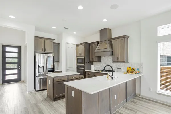 a kitchen with a sink stove and refrigerator