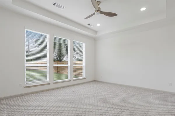a view of a livingroom with a ceiling fan and window