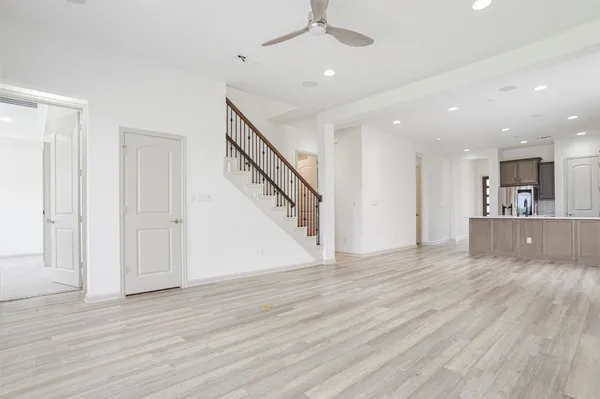 a view of a hallway with wooden floor and staircase