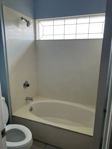 a bathroom with a shower and a toilet