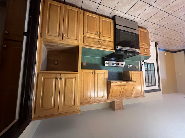 1001 Schubert Lane Kyle, TX 78640 - Photo 17 of 19 a kitchen with granite countertop a stove top oven cabinetry and a sink