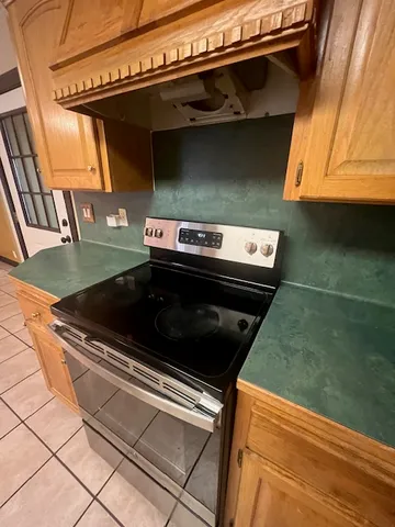a stove top oven sitting inside of a kitchen