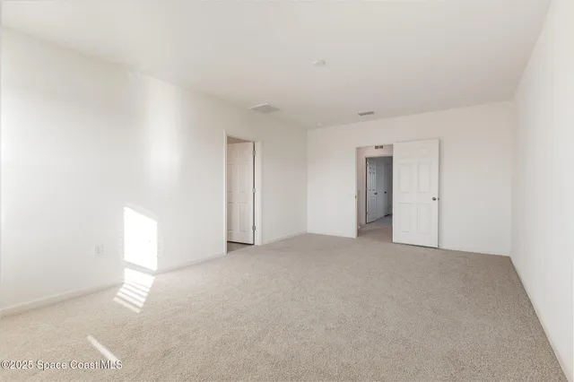 a view of an empty room and a window